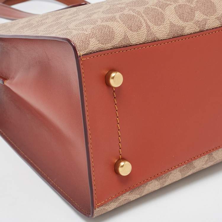 Pre Owned Coach Beige/Brown Signature Coated Canvas and Leather City Zip Tote