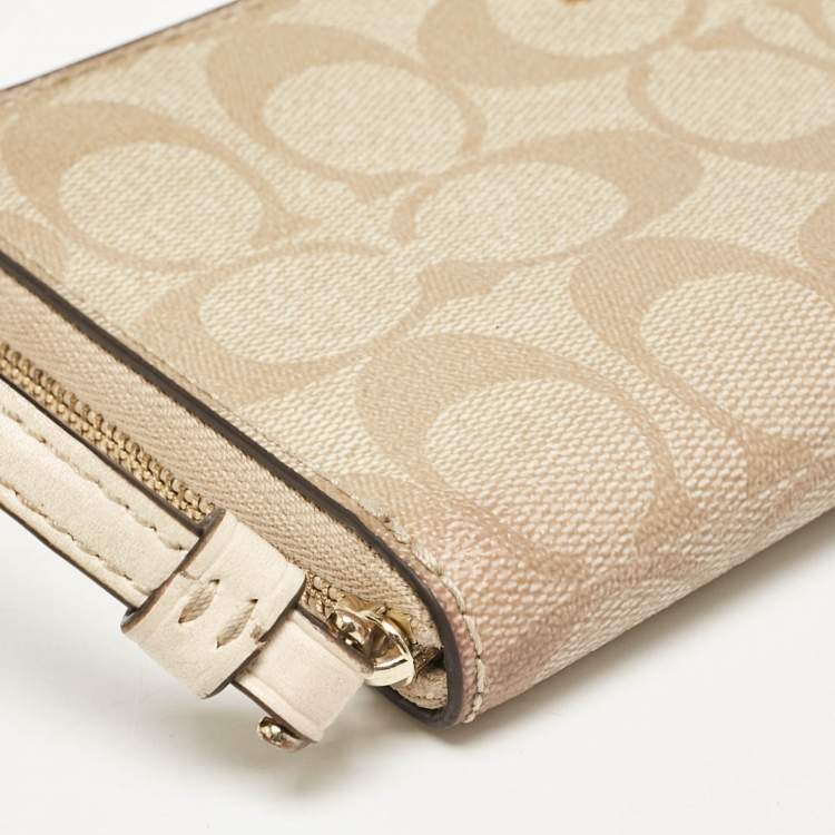 Pre Owned Coach Beige Siganture Coated Canvas and Leather Zip Around Wristlet Wallet
