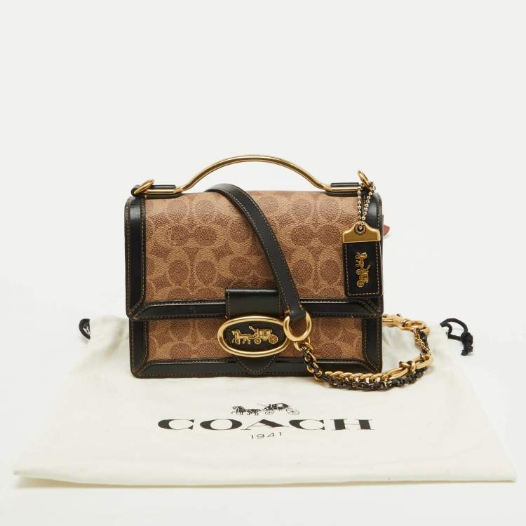 Pre Owned Coach Beige/Black Signature Coated Canvas and Leather Riley 22 Top Handle Bag
