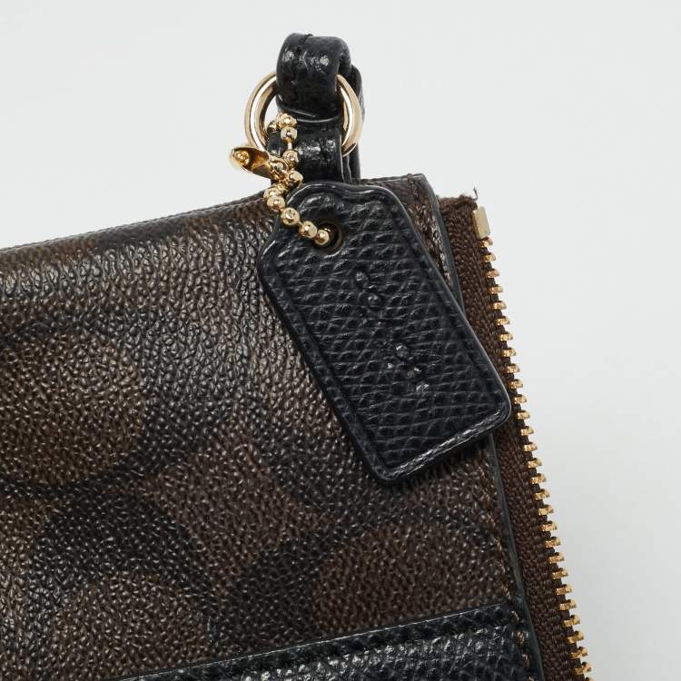 Pre Owned Coach Brown/Black Signature Coated Canvas and Leather Corner Zip Wristlet