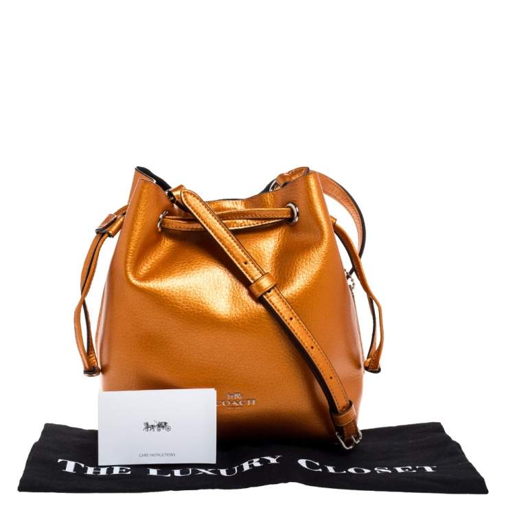 Pre Owned Coach Metallic Orange Leather Drawstring Crossbody Bag