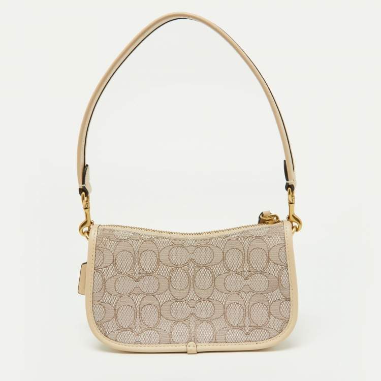 مملوكة مسبقًا Coach Beige/Cream Signature Canvas and Leather Swinger Pochette Bag