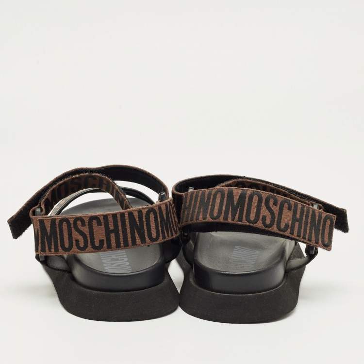 Pre Owned Moschino Brown/Black Canvas Logo Ankle Strap Flat Sandals Size 37