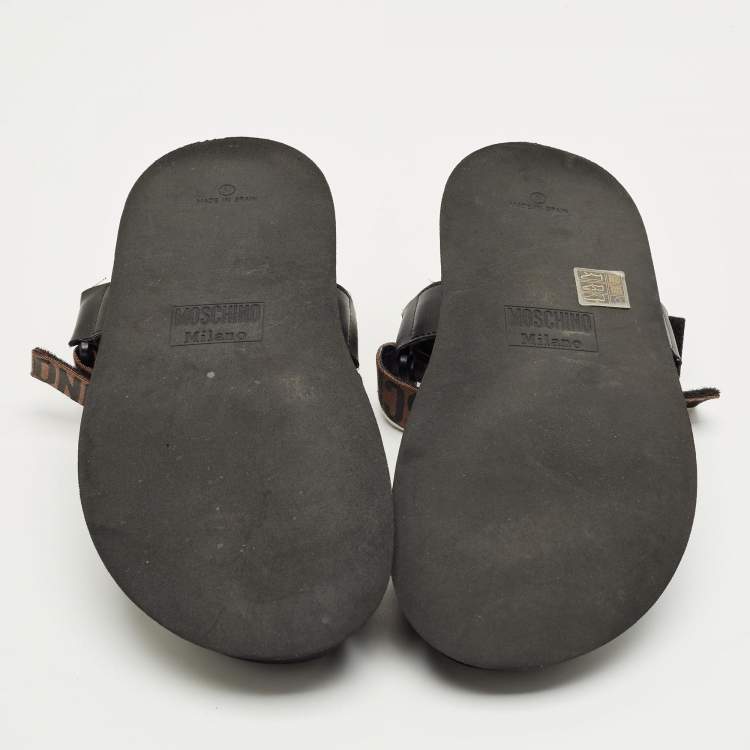 Pre Owned Moschino Brown/Black Canvas Logo Ankle Strap Flat Sandals Size 37