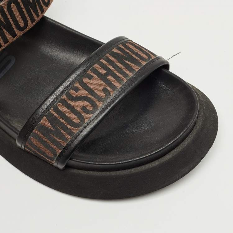 Pre Owned Moschino Brown/Black Canvas Logo Ankle Strap Flat Sandals Size 37