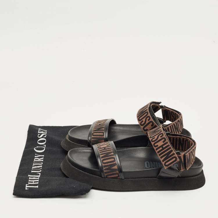 Pre Owned Moschino Brown/Black Canvas Logo Ankle Strap Flat Sandals Size 37