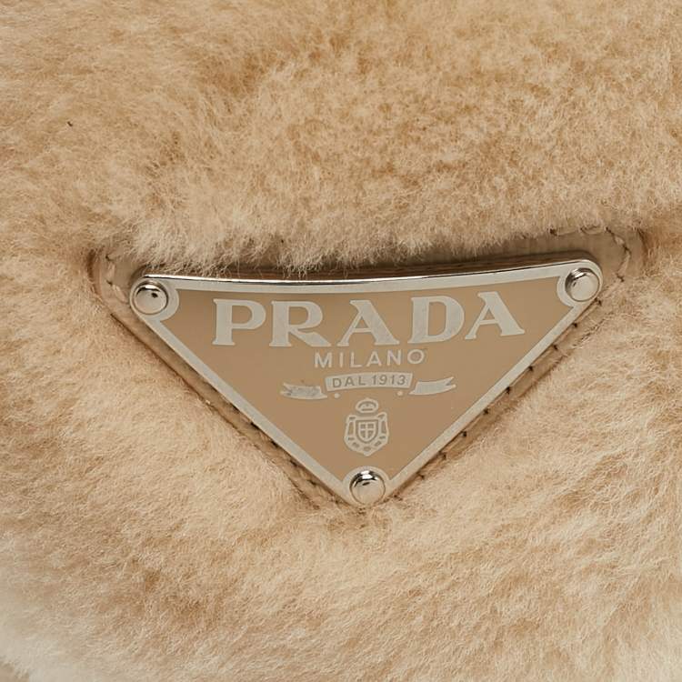Pre Owned Prada Cream Shearling Triangle Logo Plaque Earmuffs
