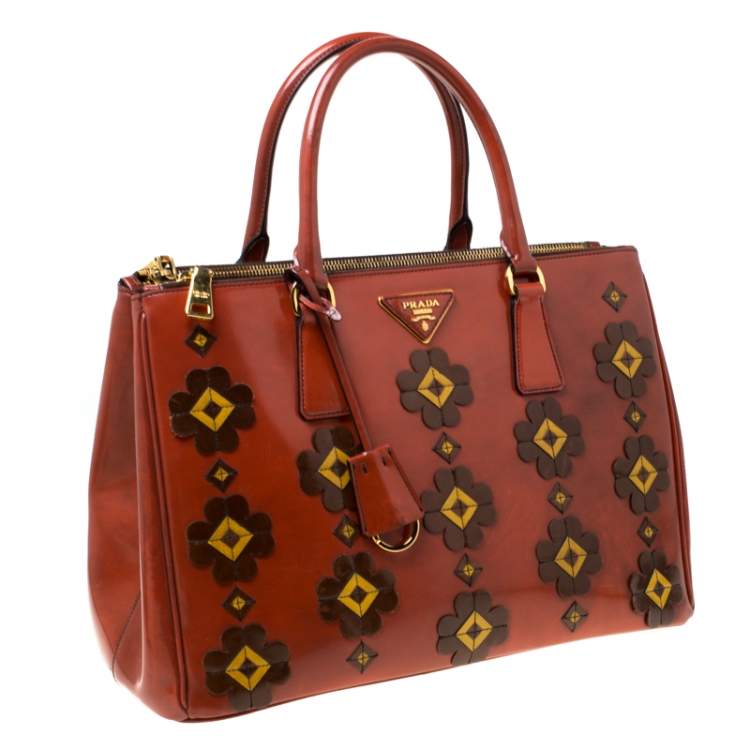 Pre Owned Prada Dark Orange Floral Applique Leather Medium Double Zip Tote