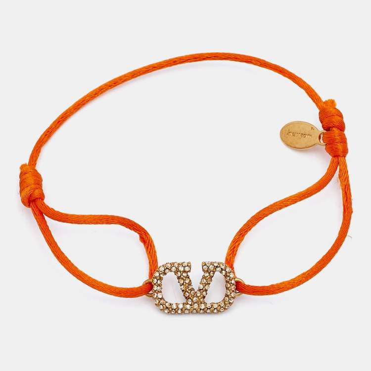 Pre Owned Valentino Vlogo Crystal Gold Tone Orange Cord Bracelet