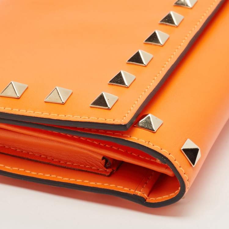 Pre Owned Valentino Neon Orange Leather Rockstud Trifold Wristlet Clutch