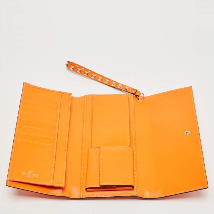 Pre Owned Valentino Neon Orange Leather Rockstud Trifold Wristlet Clutch