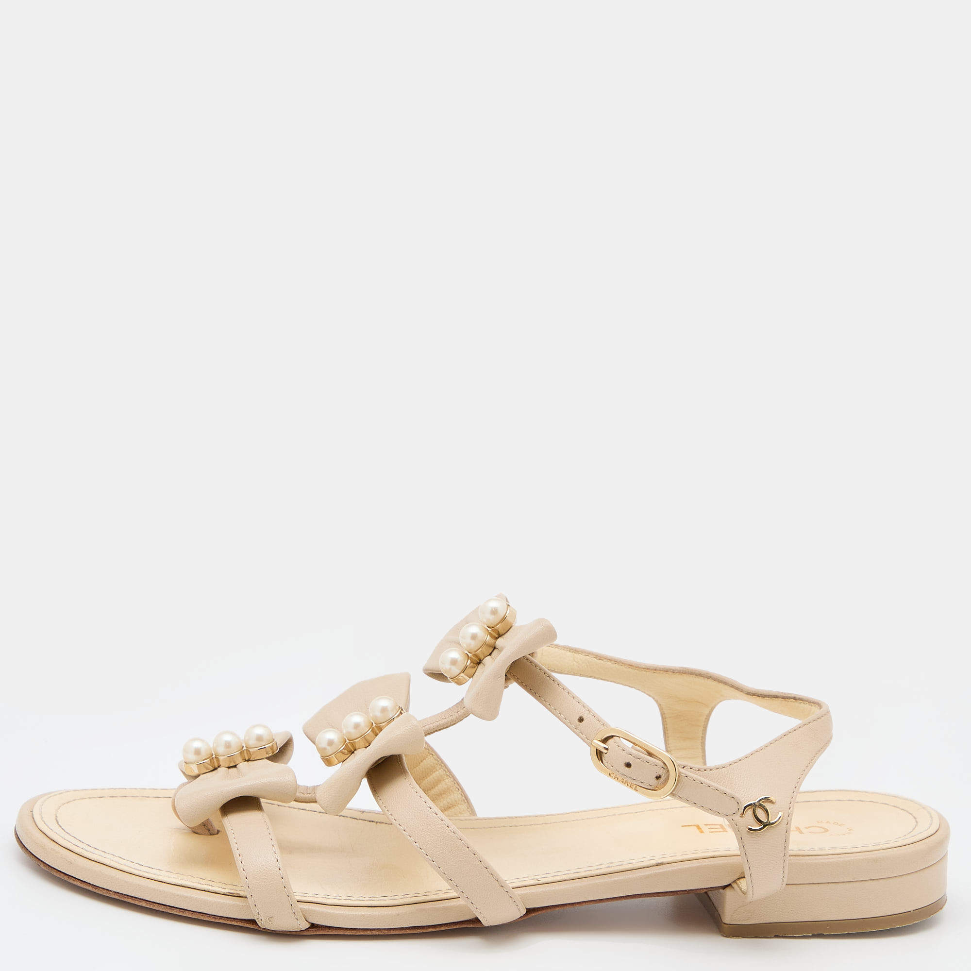 Pre Owned Chanel Cream Leather Pearl Embellished Bow CC Ankle Strap Flat Sandals Size 37.5