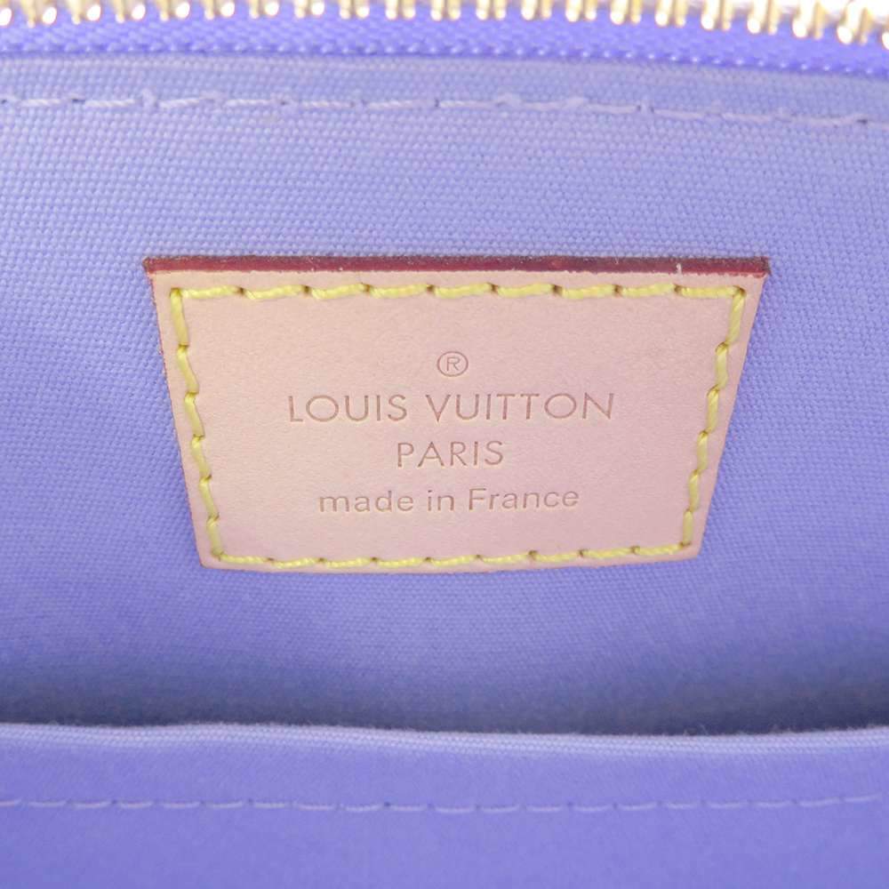 Louis Vuitton bag in purple leather and silver metal, is…