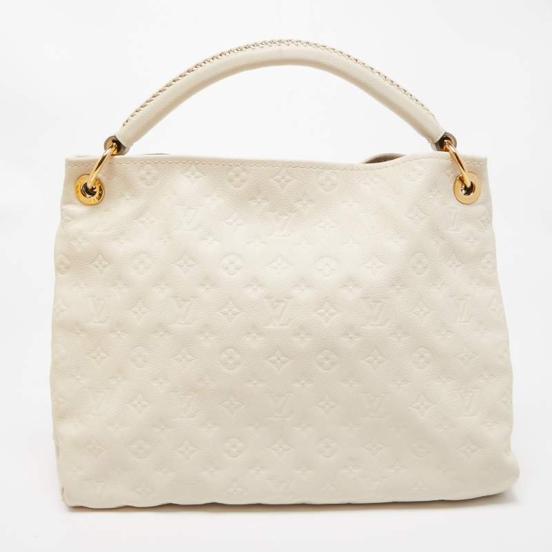 Experience the enchanting beauty of the Louis Vuitton Artsy MM Neige  Monogram Empreinte Leather Bag as you gracefully drape it over your…