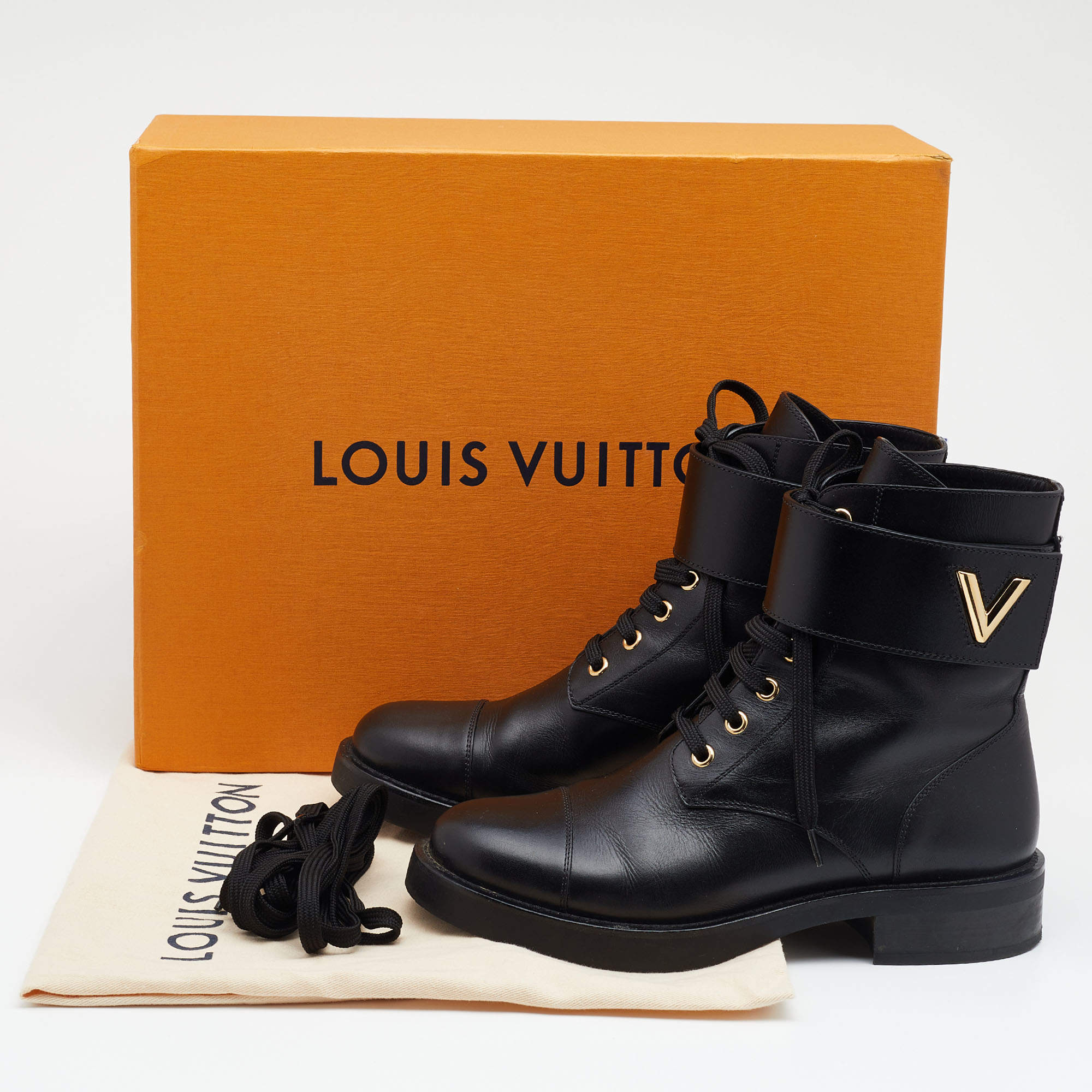 LOUIS VUITTON, Wonderland ranger, ankle boots, black calf leather,  embossed classic LV pattern, the sides with decoration of LV Twist  accessory in yellow metal (same buckle as on the bags). Vintage Clothing