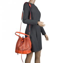 Pre Owned Moschino Orange Perforated Leather Drawstring Bucket Hobo