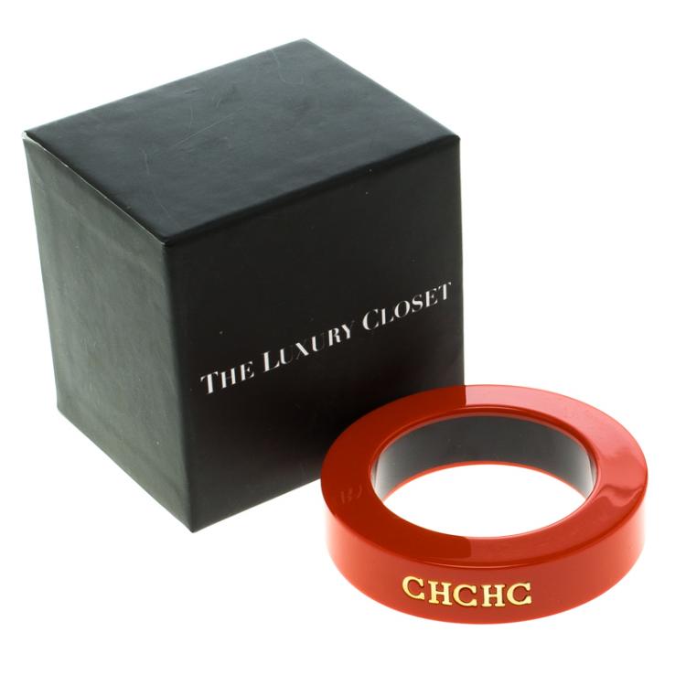 Pre Owned CH Carolina Herrera Orange Resin Gold Tone Wide Bangle 20 cm