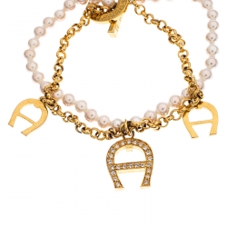 Pre Owned Aigner Crystal Logo Charm and Faux Pearl Gold Plated Layered Bracelet