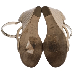 مملوكة مسبقًا Chanel Beige Quilted Leather Charm Embellished Ankle Cuff Wedge Sandals Size 36