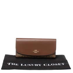 Pre Owned Coach Brown Signature PVC and Leather Saddle Flap Continental Wallet