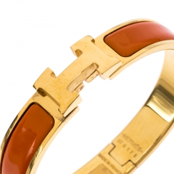 Pre Owned Hermes Clic Clac H Orange Enamel Gold Plated Narrow Bracelet PM