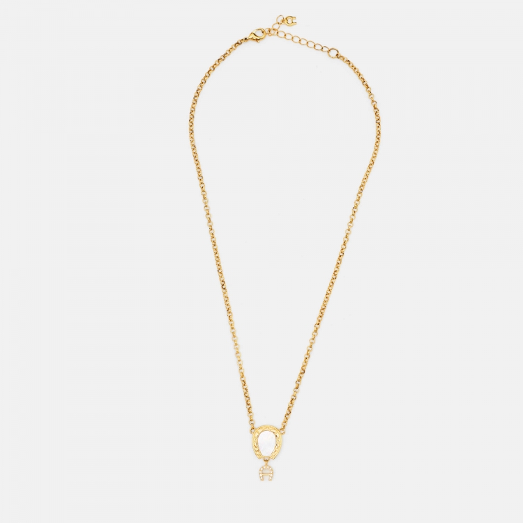 Pre Owned Aigner Gold Tone Mother of Pearl Crystal Logo Pendant Necklace