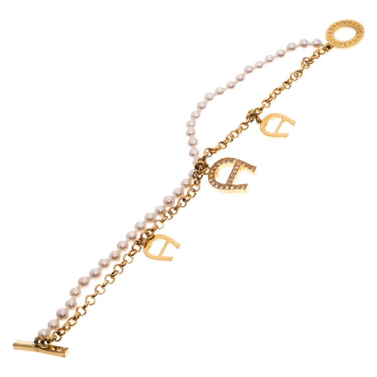 Pre Owned Aigner Crystal Logo Charm and Faux Pearl Gold Plated Layered Bracelet
