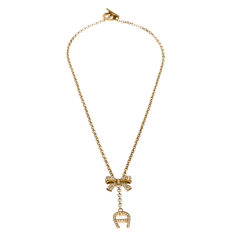 Pre Owned Aigner Crystal Studded Bow Gold Tone Long Toggle Necklace 