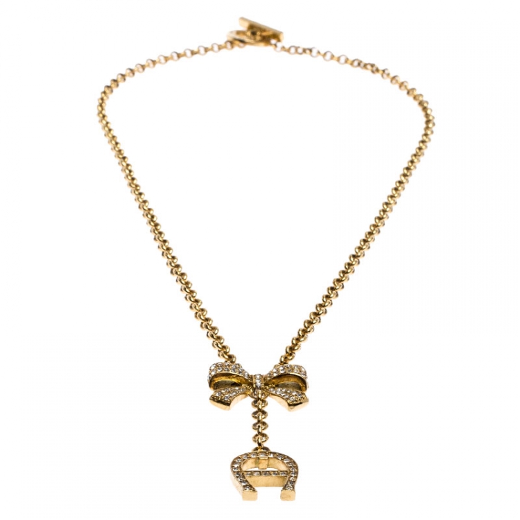 Pre Owned Aigner Crystal Studded Bow Gold Tone Long Toggle Necklace 