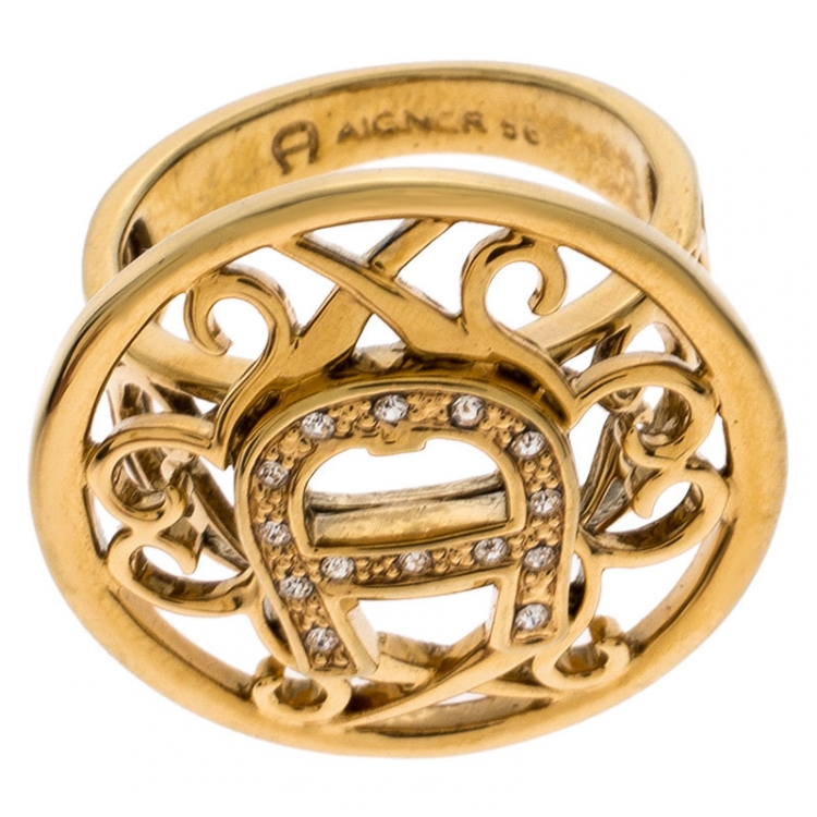 Pre Owned Aigner Gold Tone Crystal Embellished Logo Ring Size 56