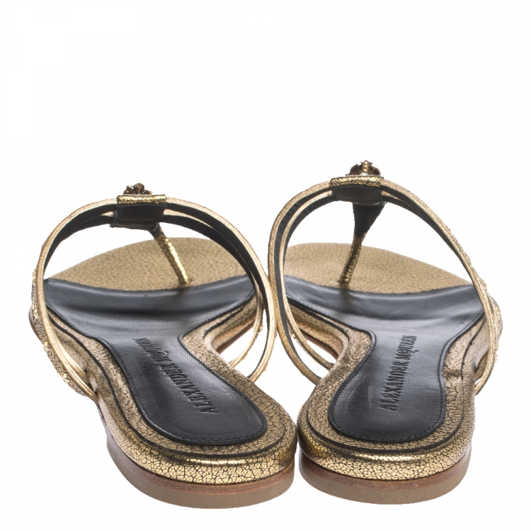 Pre Owned Alexander McQueen Metallic Gold Leather Embellished Skull Flat Thong Sandals Size 37