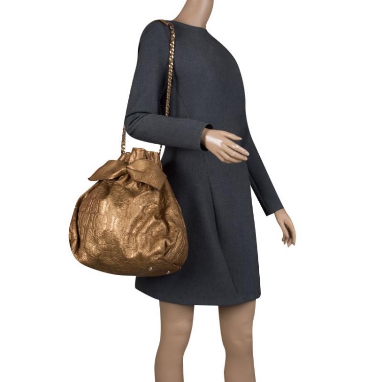Pre Owned Carolina Herrera Gold Monogram Embossed Leather Bow Bucket Shoulder Bag