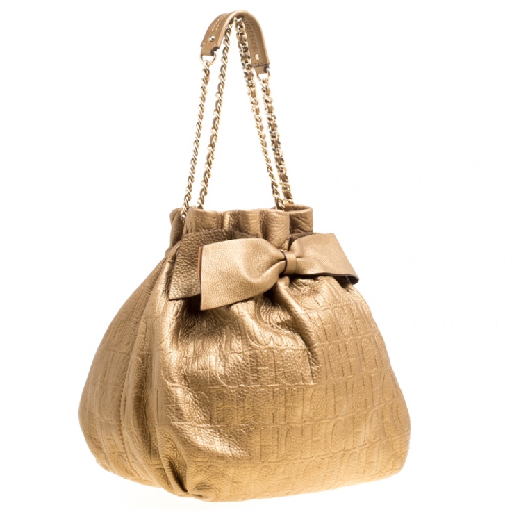 Pre Owned Carolina Herrera Gold Monogram Embossed Leather Bow Bucket Hobo