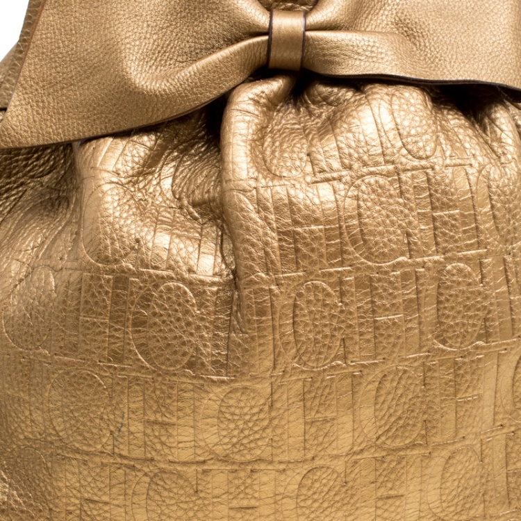 Pre Owned Carolina Herrera Gold Monogram Embossed Leather Bow Bucket Hobo