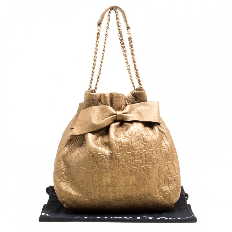 Pre Owned Carolina Herrera Gold Monogram Embossed Leather Bow Bucket Hobo