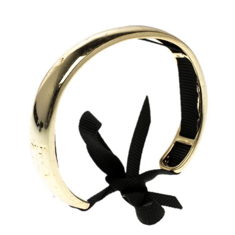 Pre Owned CH Carolina Herrera Gold Tone Ribbon Tie-up Pair of Open Cuff Bracelet