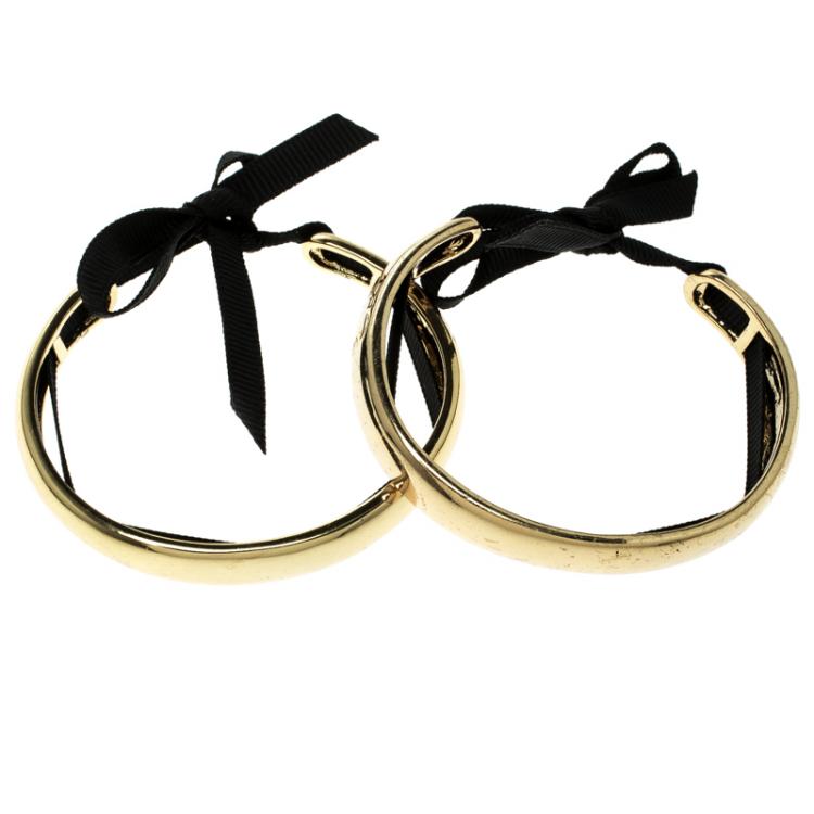 Pre Owned CH Carolina Herrera Gold Tone Ribbon Tie-up Pair of Open Cuff Bracelet