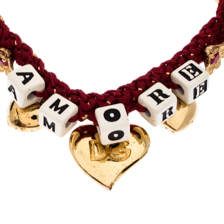 Pre Owned Dolce and Gabbana Amore Red Woven Gold Tone Charm Bracelet