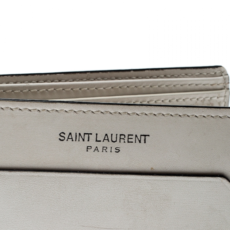 Pre Owned Saint Laurent Off White Leather Fragments East/West Bifold Wallet