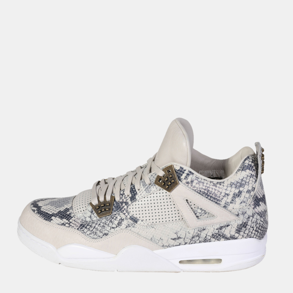Embrace luxe styling with these stylish Air Jordan 4 Retro sneakers. Dressed in a distinctive snakeskin upper these sneakers display a white make up with a white midsole and outsole with premium leather and snakeskin. Accented with metal hardware these sneakers exude classic craftsmanship and contemporary style.
