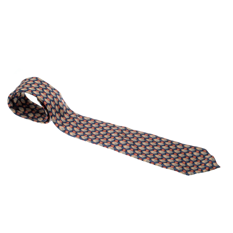 Why settle for a plain dull tie when you can add just the luxurious cut with this silk piece from Burberry Indeed this multicolored tie is splayed with the signature Novacheck and floral prints which lends it a modern appeal. Make sure to pair the tie with your simple shirts for it to stand out.