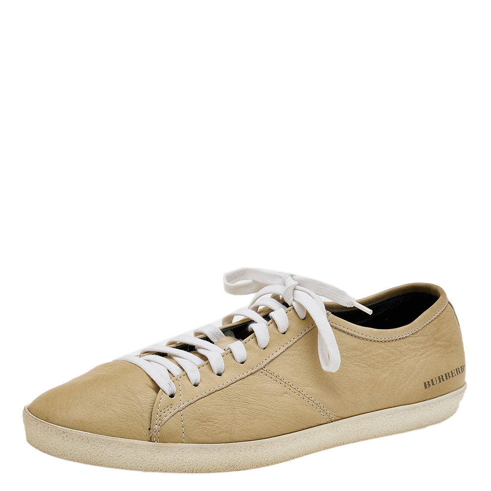 Coming in a classic low top silhouette these Burberry sneakers are a seamless combination of luxury comfort and style. They are made from leather in a beige shade. These sneakers are designed with logo details laced up vamps and comfortable insoles.