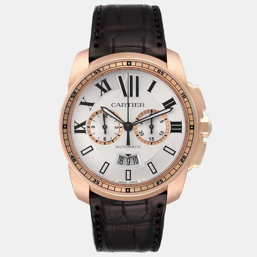 Add a sense of grandeur to your look with this stunning Cartier wristwatch. The watch boasts a silver dial featuring Roman numerals baton hour markers luminescent hands and a date window with an 18K rose gold round case and an 18K rose gold fixed bezel. It is secured by a brown leather strap with an 18K rose gold deployant buckle.