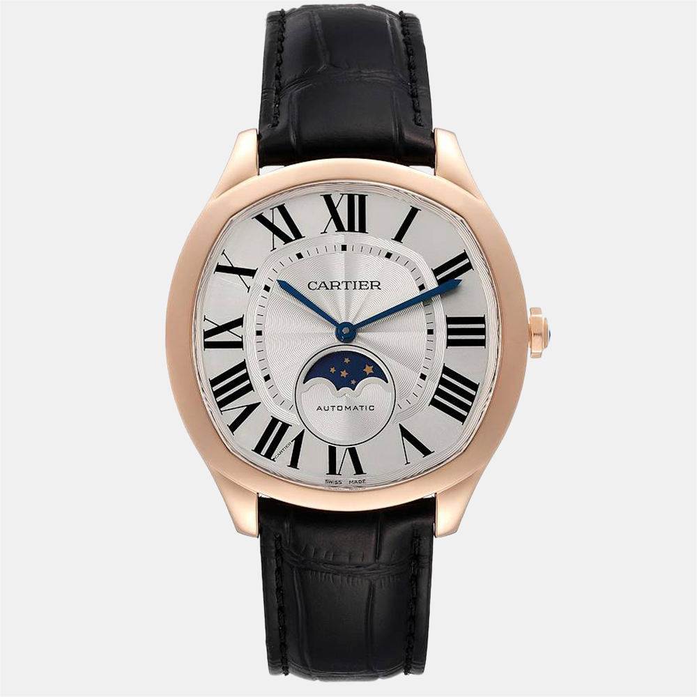This chic and luxurious watch is crafted by the house of Cartier. It has a set of black leather straps with a strategically weighted case made of 18k rose gold. The smooth domed bezel is made of 18k rose gold and the silver dial has Roman numeral hour markers and sword shaped arms.