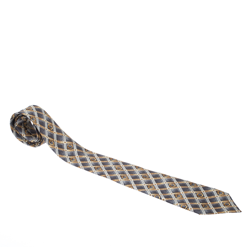 The sophisticated equestrian print on this silk tie from Celine Vintage will lend an elegant air to your daytime suiting. Adorned in the shades of grey and gold the tie is tailored with a pointed tip and a keeper loop to the rear.