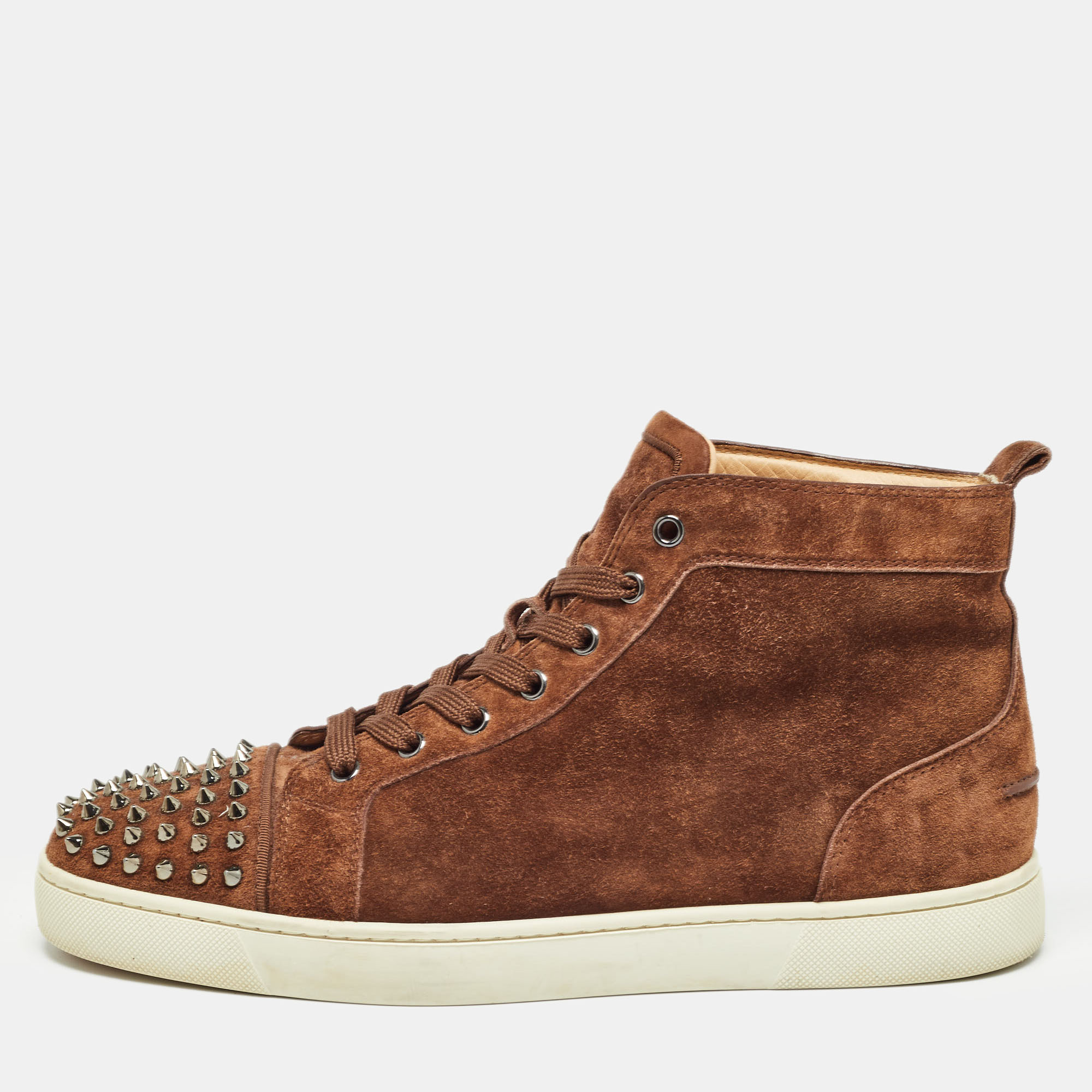 The addition of spikes makes these Christian Louboutin sneakers undeniably chic and striking. They are created from brown suede with lace up vamps pull tab at the counters and comfortable soles.