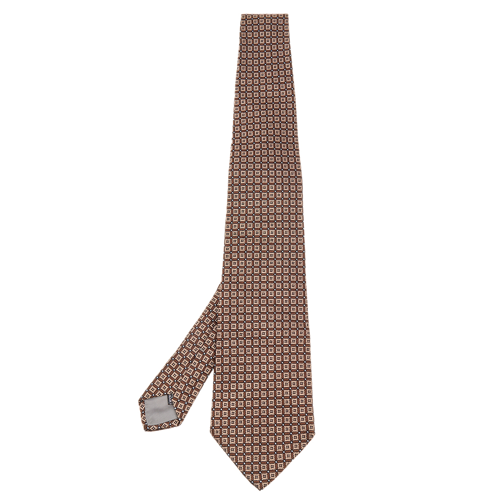 This Christian Dior tie is a perfect formal accessory that has a sharp and modern appeal. Made from luxurious materials it features intricate patterns and the brand label neatly stitched at the back. It is sure to add oodles of style to your blazers.