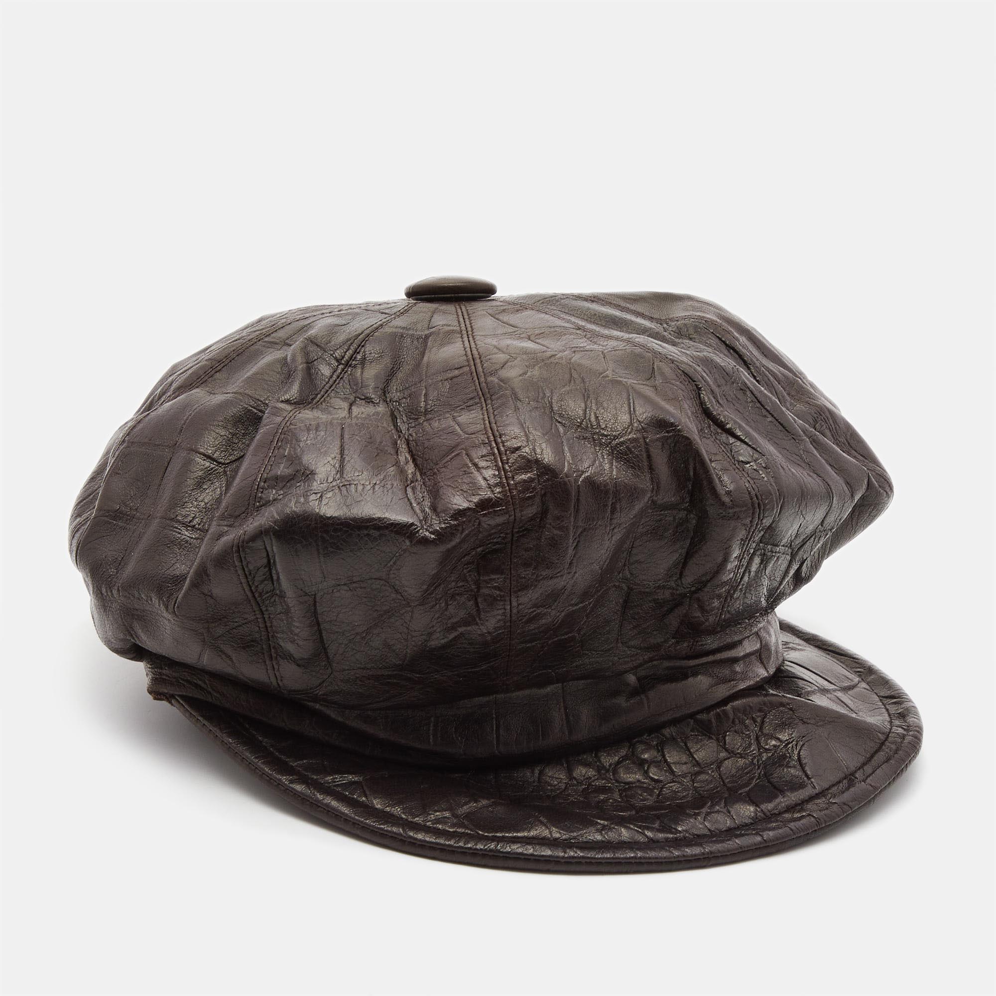 The Christian Dior Boutique newsboy hat exudes timeless elegance. Crafted with precision its rich brown hue and exquisite crocodile embossed leather showcase luxury. The newsboy silhouette adds a touch of classic charm making it a sophisticated accessory for the fashion forward individual.