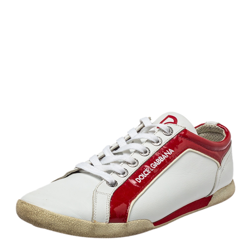These Dolce and Gabbana sneakers are simple yet stylish. Theyve been crafted from leather and feature a white exterior with a lace up vamp. These sneakers have been styled as a low top and feature contrasting red patent leather trims detailed with the brands signature on the sides. You can flaunt this trendy pair with all your casual attire.