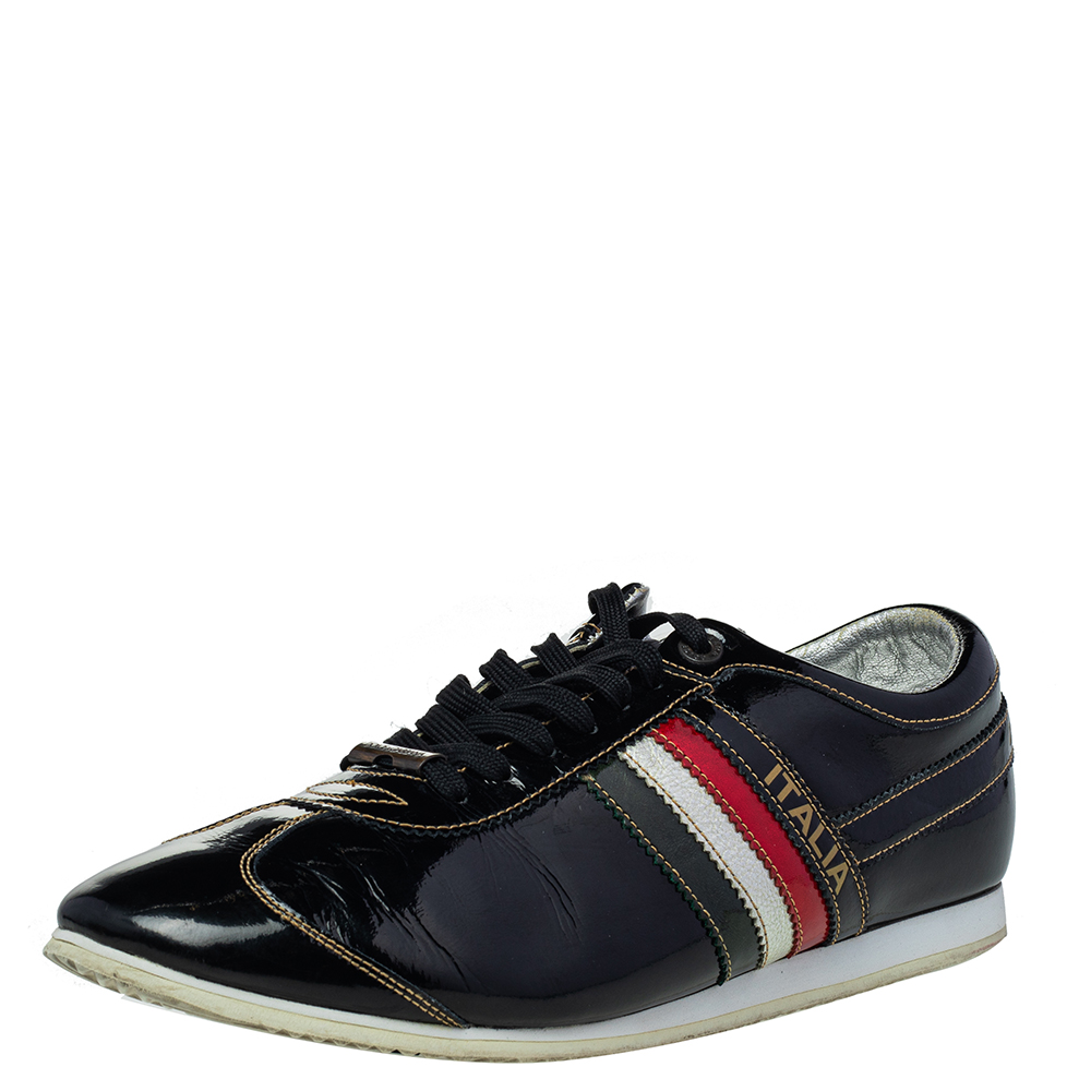 These low top sneakers by Dolce and Gabbana have been crafted from black patent leather. They come with lace up fronts and feature the brands logo on the vamps and striped panels on the sides. They are designed to deliver style and comfort and make for a great buy.